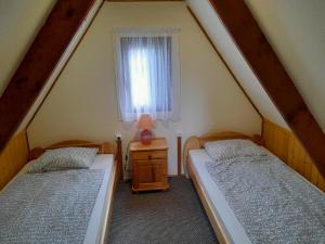 Postel nebo postele na pokoji v ubytování Őzike Apartmanházak