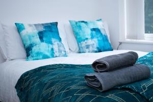 two towels sitting on top of a bed at Ideal Lodgings in Bury - Redvales in Bury