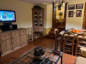 a living room with a table and a television at Arco del Tinte 10 in Guadalupe