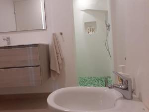 a white bathroom with a sink and a tub at Chic Coastal Hill Escape in Ventimiglia +33 photos