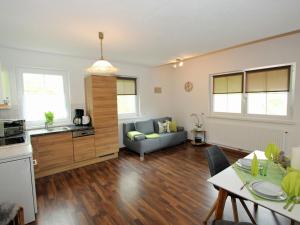 a kitchen and living room with a couch and a table at Modern Apartment in Hochgallmigg with Balcony in Hochgallmig