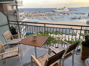 a balcony with a table and chairs and a harbor at APARTMENT PANORAMIC VIEW PALAMÓS in Palamós