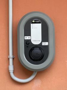 a cell phone is plugged into a wall with a hose at Eco Hotel Cleofe in Caorle