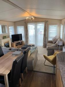 a living room with a couch and a table at Norfolk Caravan Staycation Pet Friendly in Belton