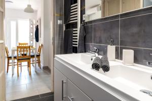 a bathroom with a white sink and a table at Németh Apartman in Keszthely +47 photos