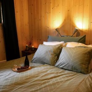 a bed with pillows and a plate of food on it at Reinunga Eco-hytta in Myrdal