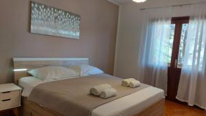 Posteľ alebo postele v izbe v ubytovaní Kuća Magnolija