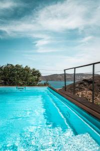 a swimming pool with a view of the water at Amelia Private Pool Apartment in Panormos Mykonos