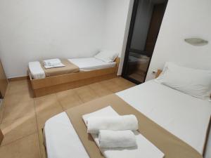a small room with two beds and a mirror at Apartments Mare Budva in Budva