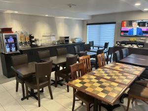 a restaurant with tables and chairs and a chess board at Econo Lodge Airport Quebec in Quebec City