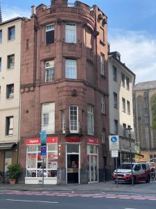 a brick building on the corner of a street at DOM APARTS in Cologne