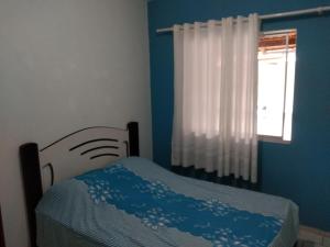 A bed or beds in a room at Casa de praia navegantes, próximo aeroporto