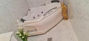 a white sink on the wall of a bathroom at Aprtmani "M" br4 in Topola +7 photos