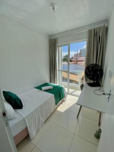 a bedroom with a bed and a large window at Temporada 737 in Aracaju +7 photos