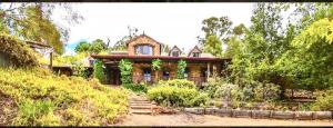 a large house on the side of a hill at Le Petit Chateau Homestead Bridgetown in Bridgetown