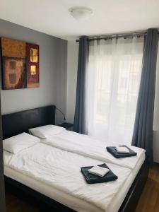 a bedroom with a bed with two towels on it at Beautiful Apartment near Geneva in Saint-Julien-en-Genevois