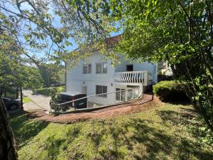 a white house with a deck and a yard at Villa ''M&A'' in Sarajevo