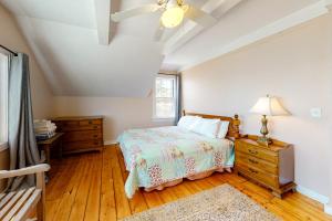 a bedroom with a bed and a ceiling fan at Retreat Cottage in Plymouth