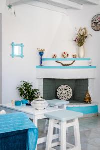 a living room with blue shelves and a fireplace at Pastalia Cottage in Skopelos Town