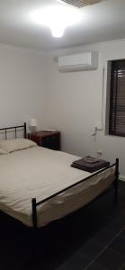a bedroom with a bed in a room at Cartledge Ave studio and house homestay in Whyalla