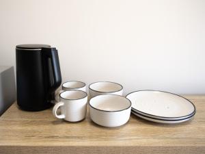 a group of cups and plates sitting on a table at Inala Hotel in Brisbane