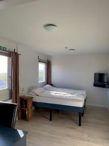 a bedroom with a bed and a window at Gil guesthouse in Búðardalur