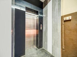 a shower with a metal door in a bathroom at HOTEL ROYAL PARADISE in Coimbatore