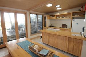 a large kitchen with a table and a refrigerator at The Jetty at Cowan Cowan in Cowan Cowan