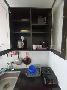a small kitchen with a sink and a counter at Apartment Gateway Pasteur by Cristiano Liwu in Bandung