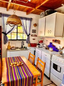 a kitchen with a table with a colorful table cloth at Casa Heidi, Apaneca in Apaneca