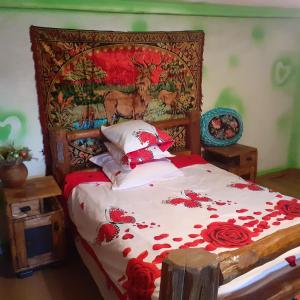 a bedroom with a bed with red flowers on it at Room in Guest room - Cozy Sejour Near Forest for 2 people in Roşia Montană
