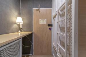 a room with a door with a lamp and a desk at On the Bed Hostel in Bangkok