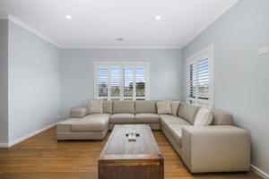 a living room with a couch and a coffee table at The Oxley Estate in Portarlington