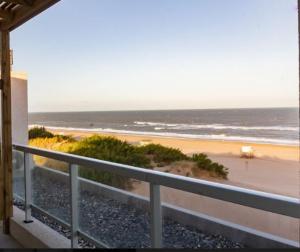a balcony with a view of the beach and the ocean at Flow Apart & Spa in Las Gaviotas