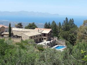 a house on a hill with a swimming pool at Case Vacanza Baglio Ciambre in Borgetto