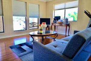 a living room with a couch and a table at Regency Inn & Suites in Gladewater