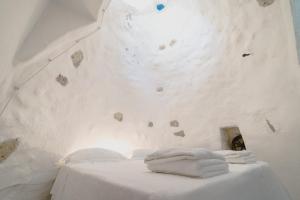 two towels on a table in a room with a rock wall at Villa Tina ai Piedi del Faro di Leuca in Leuca