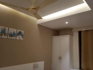 a ceiling fan in a room with a white cabinet at Providence, Port Blair in Port Blair