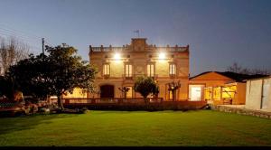 a large house with lights on the front of it at Masia La Bomba in Masnou