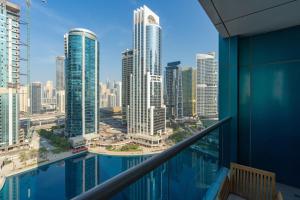 a view of the city from the balcony of a skyscraper at ATRIA - Luxury 2 Bed - FAST WIFI - Lake Views in Dubai