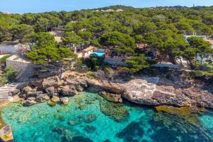 an aerial view of a beach with turquoise water at Villa Lumb in Capdepera