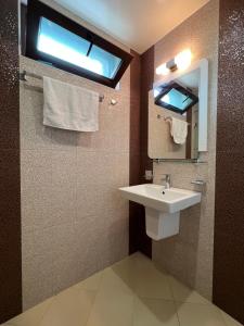 a bathroom with a sink and a mirror and a window at TEA Apartments in Pomorie +17 photos