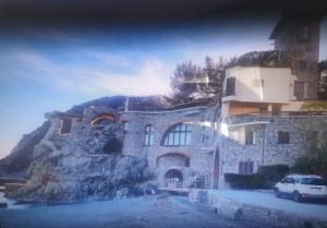 a building with a car parked in front of it at Palme CloseToGigante Junior Suites in Monterosso al Mare