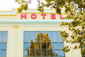 a hotel sign on top of a building at Reikartz Kokand in Kokand