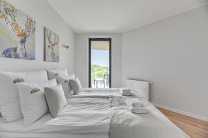 Posteľ alebo postele v izbe v ubytovaní Tarasy Bałtyku Sea Side, Sauna & Gym by Downtown Apartments