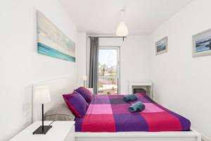 A bed or beds in a room at MEDANO4YOU Ocean Family Dream Holiday Home