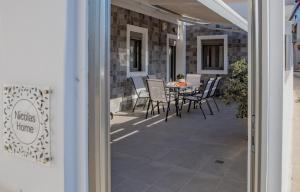 a patio with chairs and a table on a building at Nicolas Home in Ierapetra