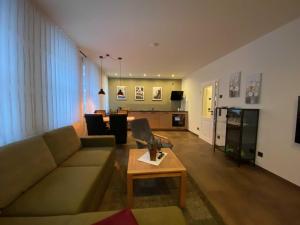 a living room with a couch and a table at Ferienwohnung Heideviertel in Wernigerode