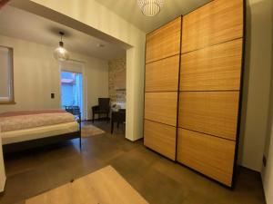 a bedroom with a bed and a large wooden closet at Ferienwohnung Heideviertel in Wernigerode +2 photos