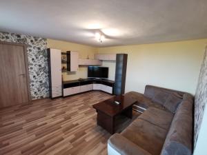a living room with a couch and a table at Kabakum Holiday Apartment in Varna City
